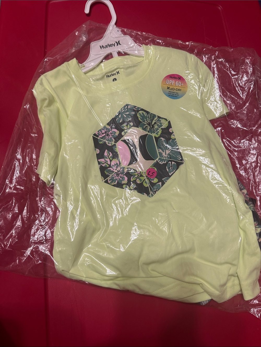 Hurley Yellow Short Sleeve Tee with Floral Geometric Graphic . With swim trunks.